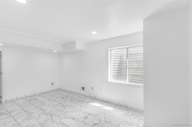 524 Rider Ridge Dr, Longmont, CO 80504 - empty room with visible vents, marble finish floor, baseboards, and recessed lighting
