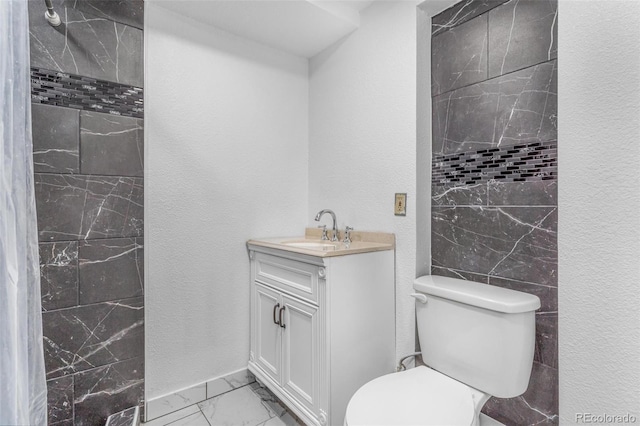 524 Rider Ridge Dr, Longmont, CO 80504 - bathroom featuring vanity, toilet, a textured wall, and marble finish floor