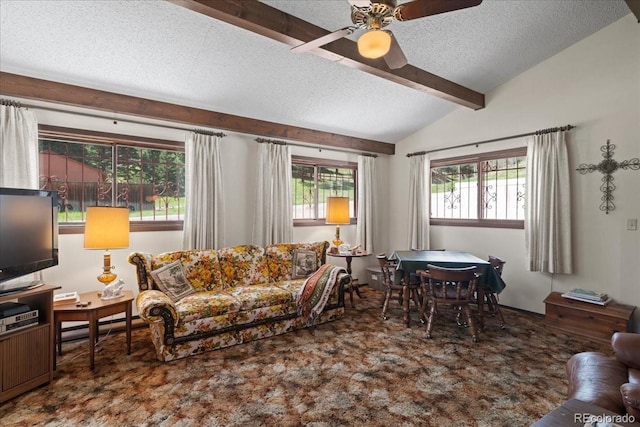 living room featuring ceiling fan, a healthy amount of sunlight, a textured ceiling, and lofted ceiling with beams