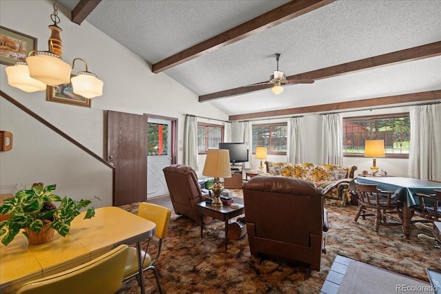 living room featuring ceiling fan, lofted ceiling with beams, and a textured ceiling