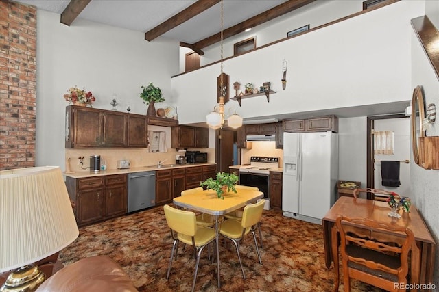 kitchen with brick wall, beamed ceiling, white appliances, dark brown cabinetry, and sink