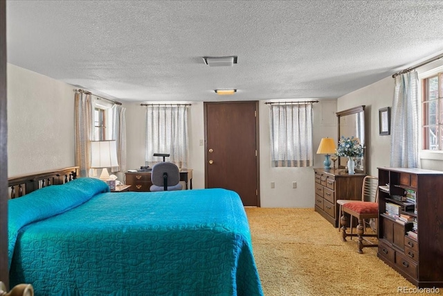 carpeted bedroom featuring a textured ceiling