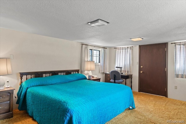 bedroom featuring a textured ceiling and carpet floors