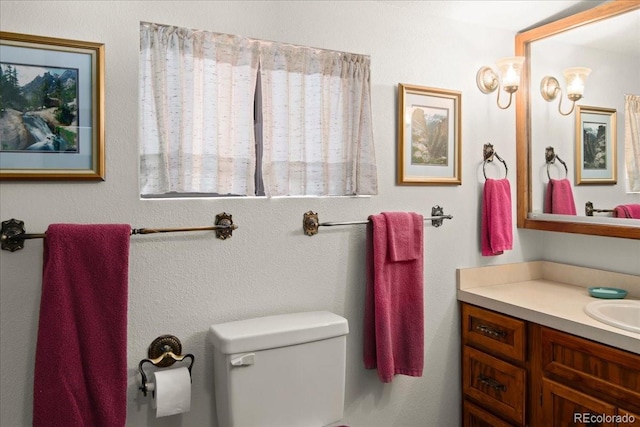 bathroom featuring toilet and large vanity