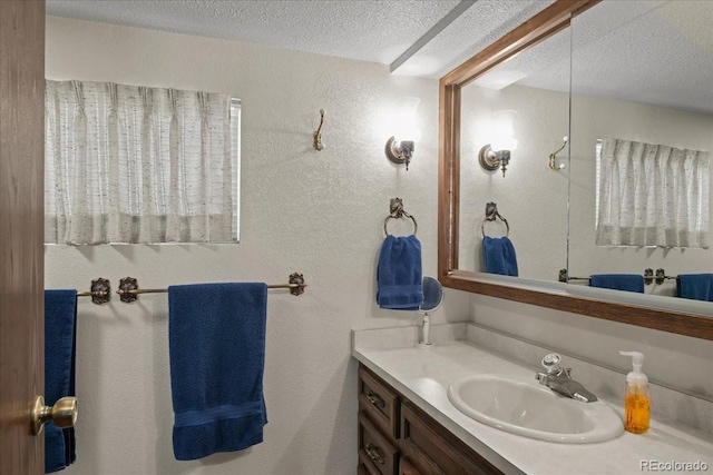 bathroom with vanity and a textured ceiling