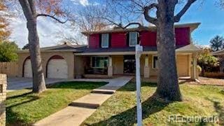 front of property with a front yard and a garage