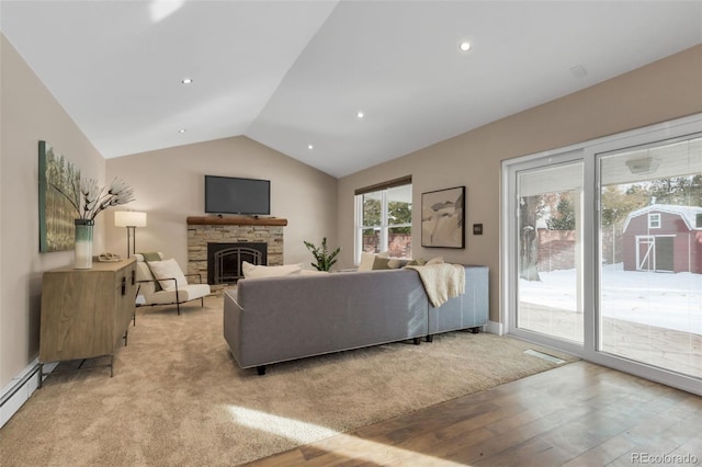 living room with a stone fireplace, lofted ceiling, a baseboard radiator, and light hardwood / wood-style flooring