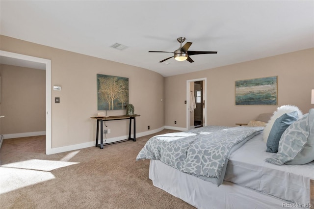 bedroom with light carpet, ensuite bath, and ceiling fan