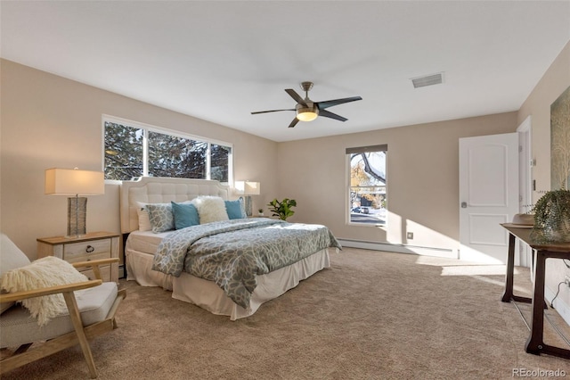 bedroom featuring light colored carpet, baseboard heating, and ceiling fan