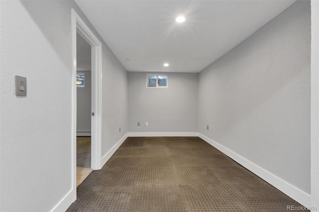 basement with carpet floors and baseboard heating