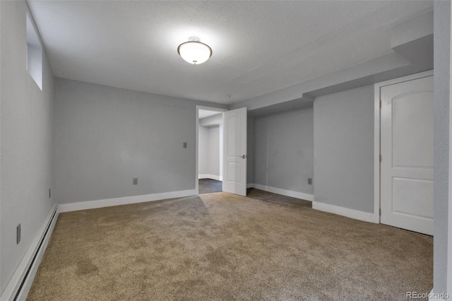 basement featuring carpet flooring, a textured ceiling, and a baseboard radiator