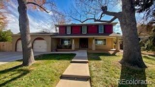 front of property featuring a front yard and a garage