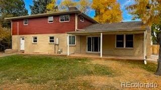 back of property with a patio and a lawn