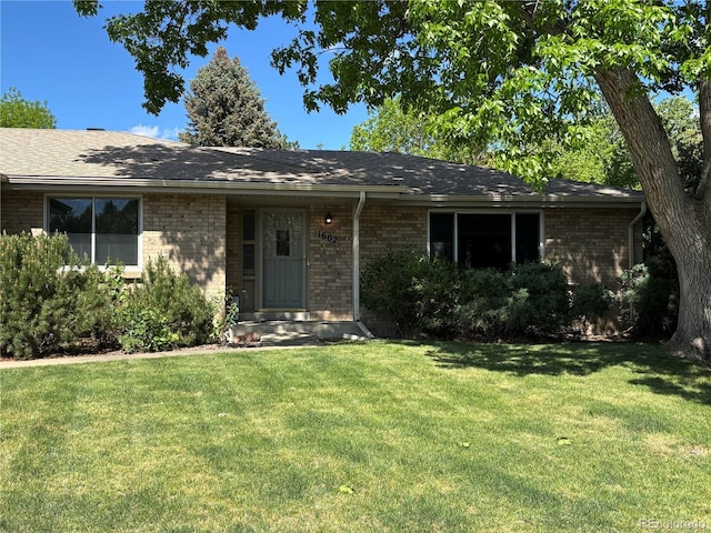 1602 S Lamar St, Lakewood, CO 80232 - ranch-style house with brick siding and a front yard