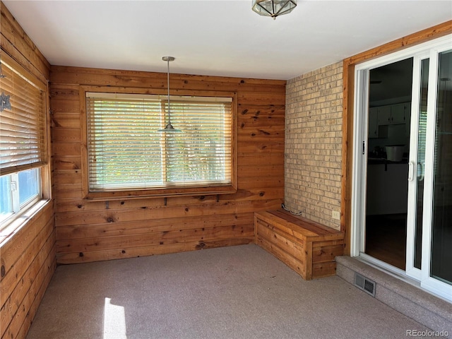 1602 S Lamar St, Lakewood, CO 80232 - unfurnished dining area featuring carpet floors and wood walls
