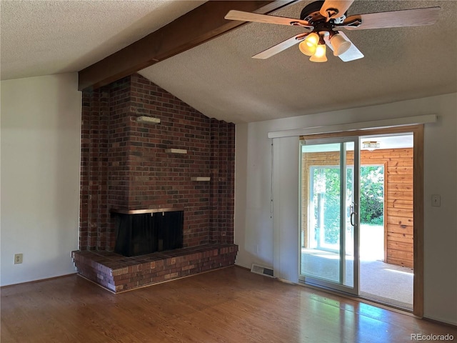 1602 S Lamar St, Lakewood, CO 80232 - unfurnished living room with a textured ceiling, wood finished floors, a ceiling fan, and a brick fireplace