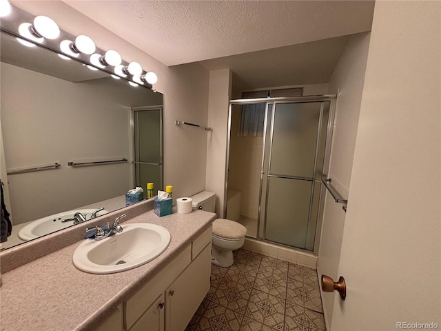 1602 S Lamar St, Lakewood, CO 80232 - bathroom with toilet, vanity, a shower stall, and a textured ceiling