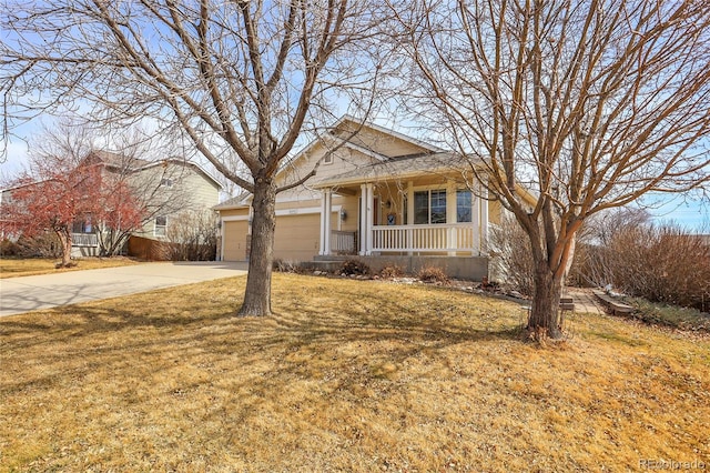 view of front of property featuring covered porch, driveway, a front yard, and a garage