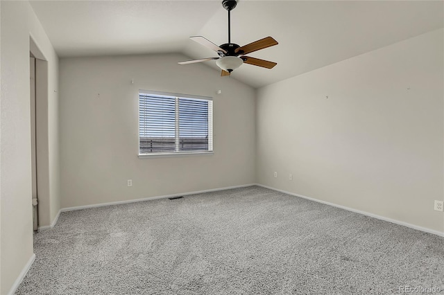 spare room featuring ceiling fan, baseboards, carpet, and lofted ceiling