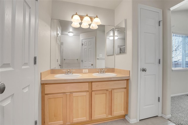 full bathroom featuring double vanity, tile patterned flooring, a closet, and a sink