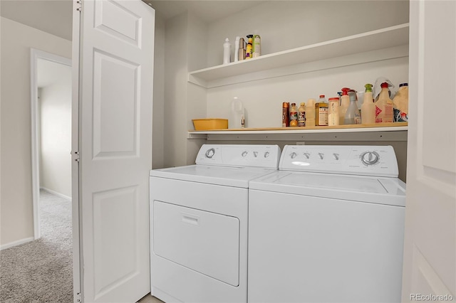 laundry area with washer and dryer, carpet flooring, baseboards, and laundry area