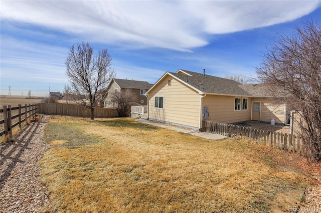 exterior space with a lawn and a fenced backyard