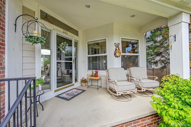 view of patio / terrace featuring a porch and visible vents