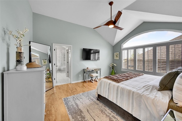 bedroom with a ceiling fan, vaulted ceiling, and light wood-style flooring