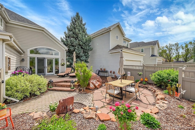 view of patio / terrace featuring fence, a wooden deck, and outdoor dining area