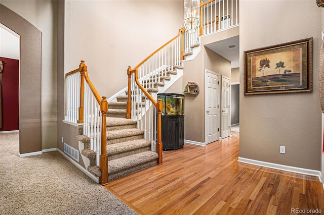 5569 S Helena St, Centennial, CO 80015 - staircase featuring a high ceiling and wood finished floors