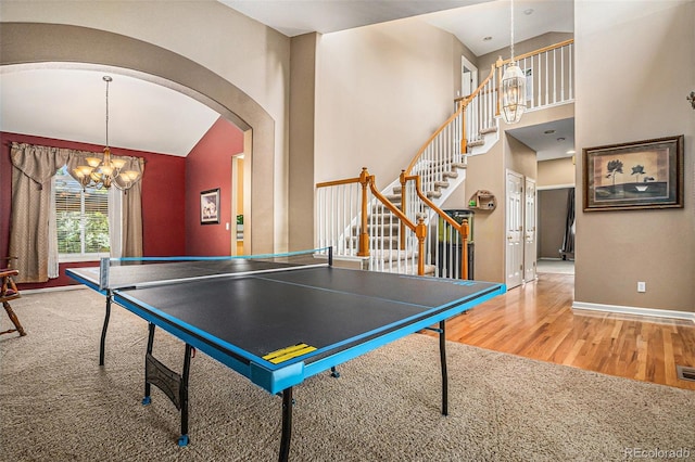 5569 S Helena St, Centennial, CO 80015 - rec room featuring wood finished floors, a chandelier, arched walkways, and high vaulted ceiling