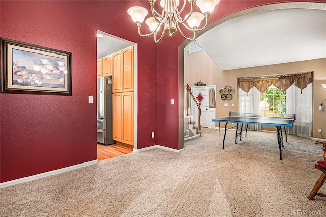5569 S Helena St, Centennial, CO 80015 - rec room with arched walkways, a chandelier, light colored carpet, high vaulted ceiling, and a textured wall