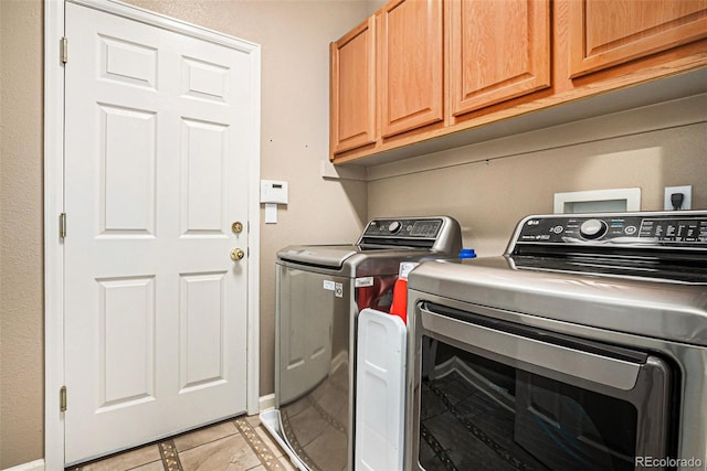 5569 S Helena St, Centennial, CO 80015 - laundry area featuring washing machine and dryer, cabinet space, and light tile patterned floors