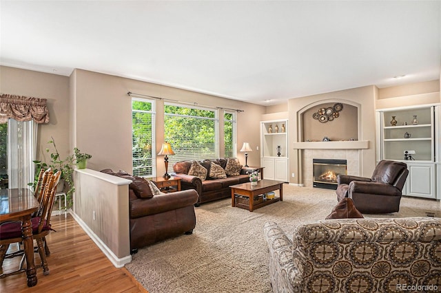 5569 S Helena St, Centennial, CO 80015 - living area featuring a tile fireplace, wood finished floors, and built in shelves