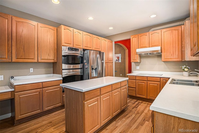 5569 S Helena St, Centennial, CO 80015 - kitchen featuring under cabinet range hood, appliances with stainless steel finishes, light wood-style floors, a kitchen island, and recessed lighting