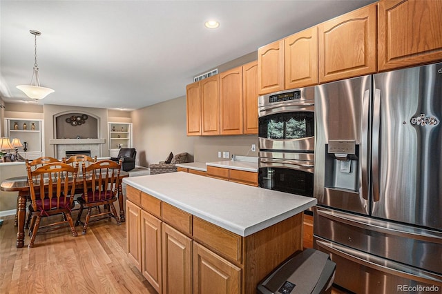 5569 S Helena St, Centennial, CO 80015 - kitchen featuring stainless steel appliances, light wood-style flooring, a kitchen island, light countertops, and open floor plan