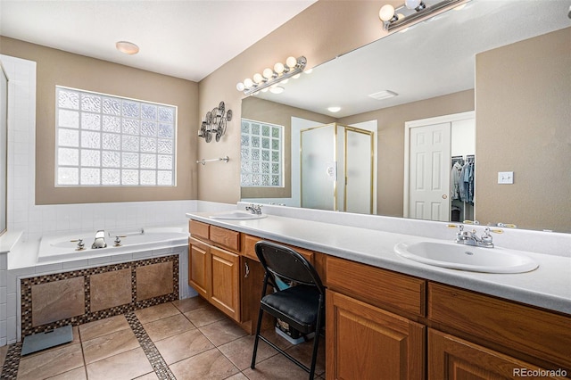5569 S Helena St, Centennial, CO 80015 - bathroom with double vanity, tile patterned flooring, a shower stall, a garden tub, and inlaid floor details