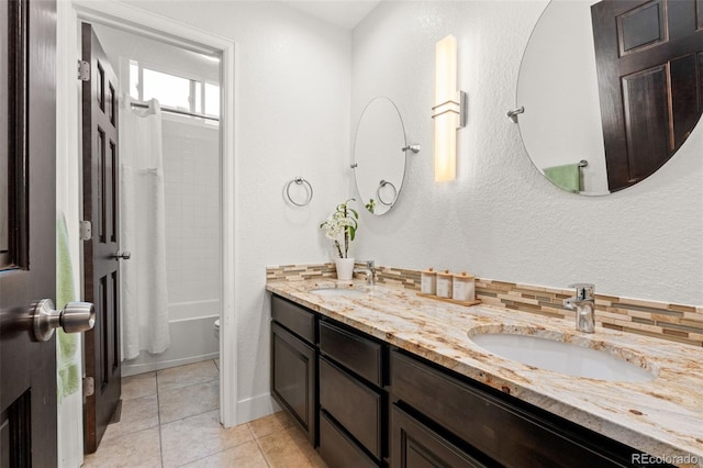 bathroom with double vanity, a sink, shower / bathtub combination with curtain, and tile patterned floors
