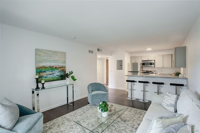 living room featuring baseboards, dark wood-style floors, and visible vents