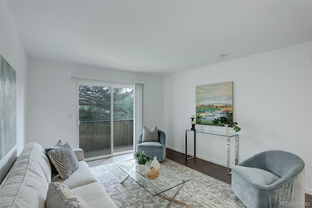 living room featuring baseboards and wood finished floors