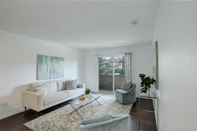 living room featuring baseboards and dark wood-style floors
