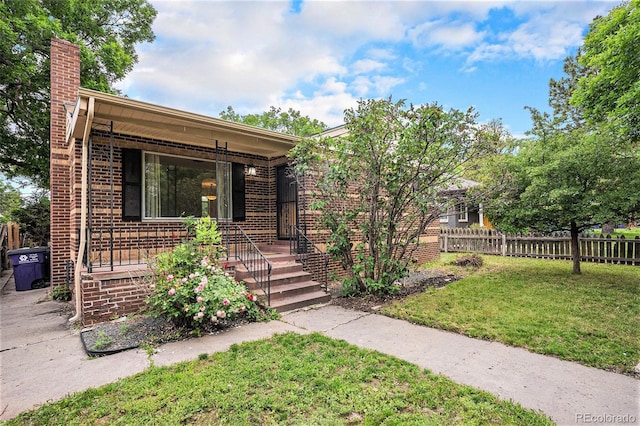 2526 W 39th Ave, Denver, CO 80211 - view of front of house with a chimney, covered porch, and brick siding