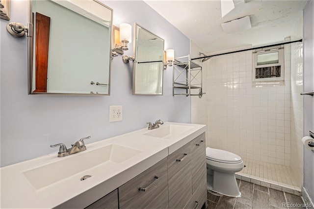 2526 W 39th Ave, Denver, CO 80211 - bathroom featuring wood finished floors, double vanity, toilet, and a tile shower