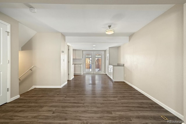 unfurnished room with french doors, dark wood-type flooring, and baseboards