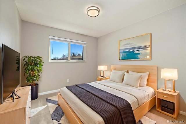 bedroom featuring light colored carpet and baseboards