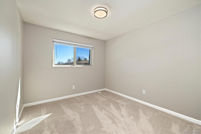 unfurnished room featuring baseboards and carpet