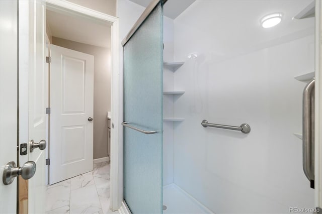 full bath featuring marble finish floor and a shower stall