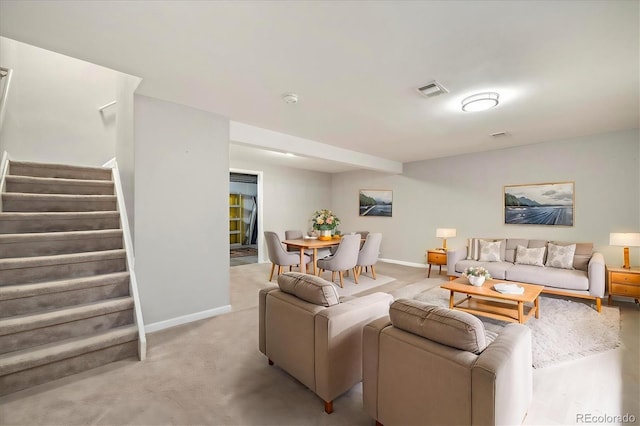 living area with stairs, baseboards, visible vents, and light colored carpet