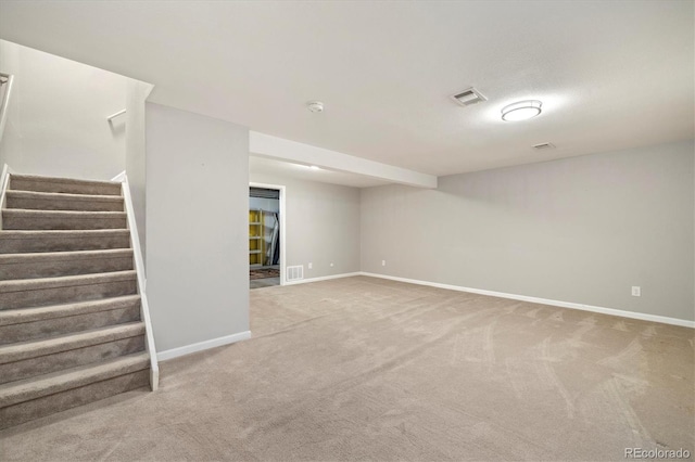 empty room featuring visible vents, carpet floors, baseboards, and stairs