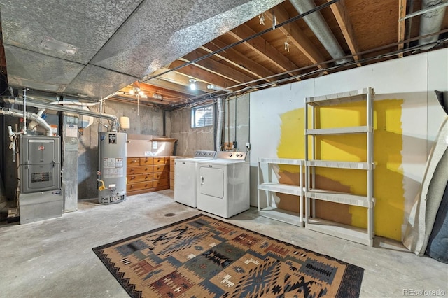 basement with washer and clothes dryer, heating unit, and gas water heater